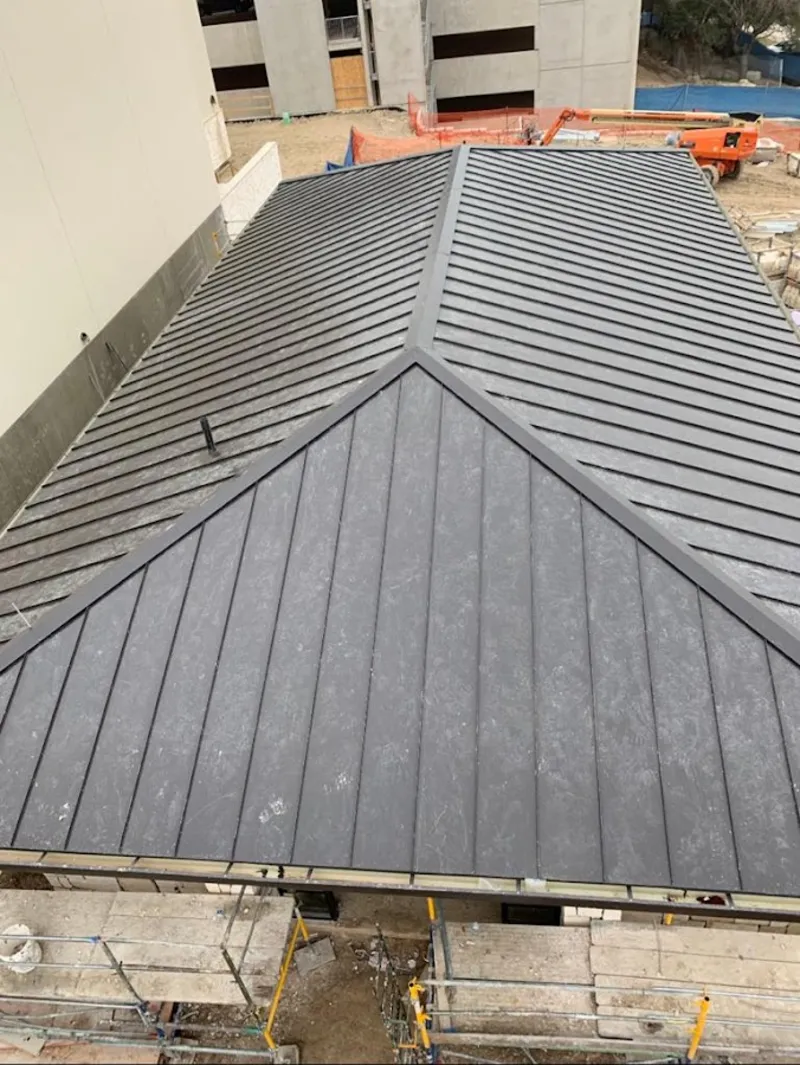 Commercial metal roof construction with crane equipment in Hutchinson