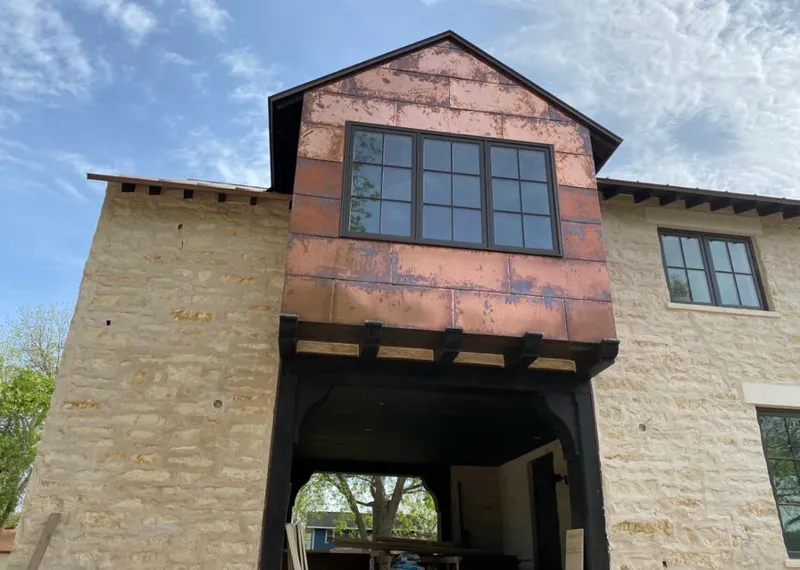 Copper metal panel facade on a stone building for Roof Repair in Hutchinson
